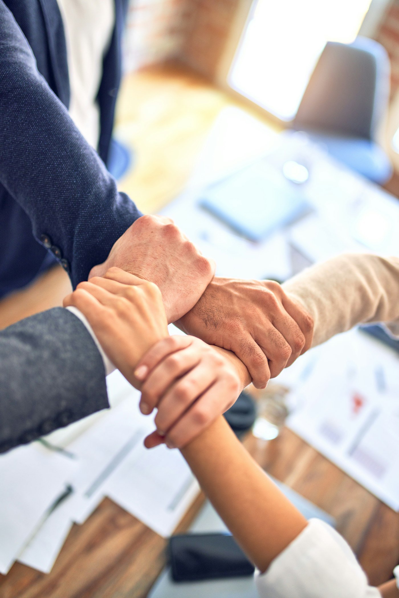 Hands around a table during a planning meeting